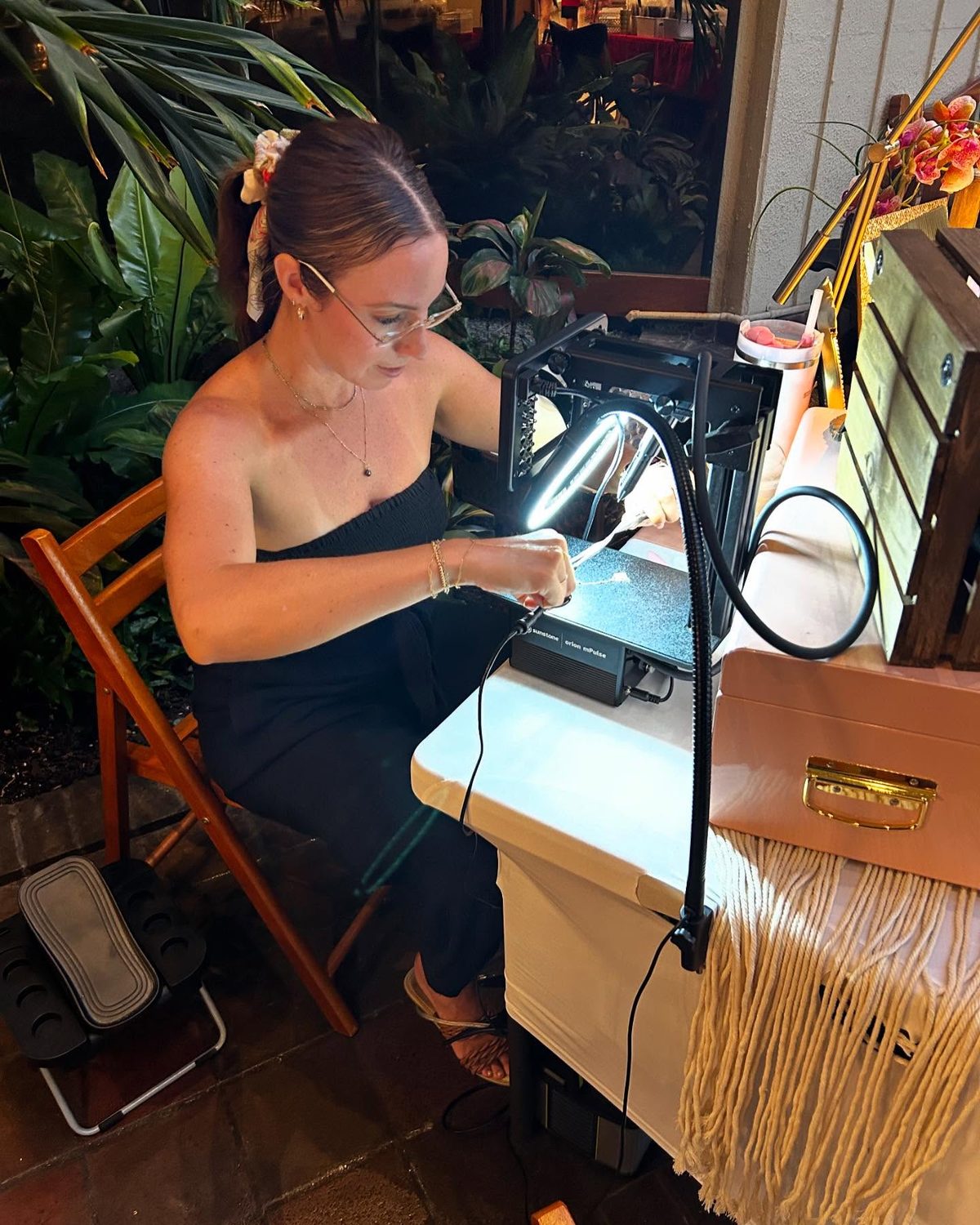 Li'ili'i Links jeweler welding a chain closed at the pop-up table
